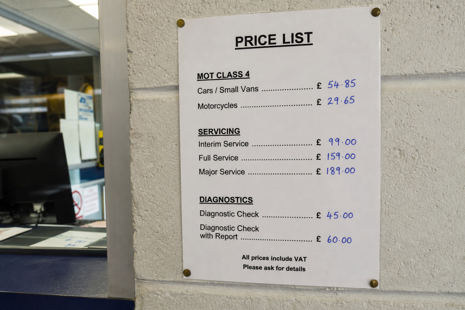 A printed price list pinned to a workshop wall, MOT Class 4 at £54.85.